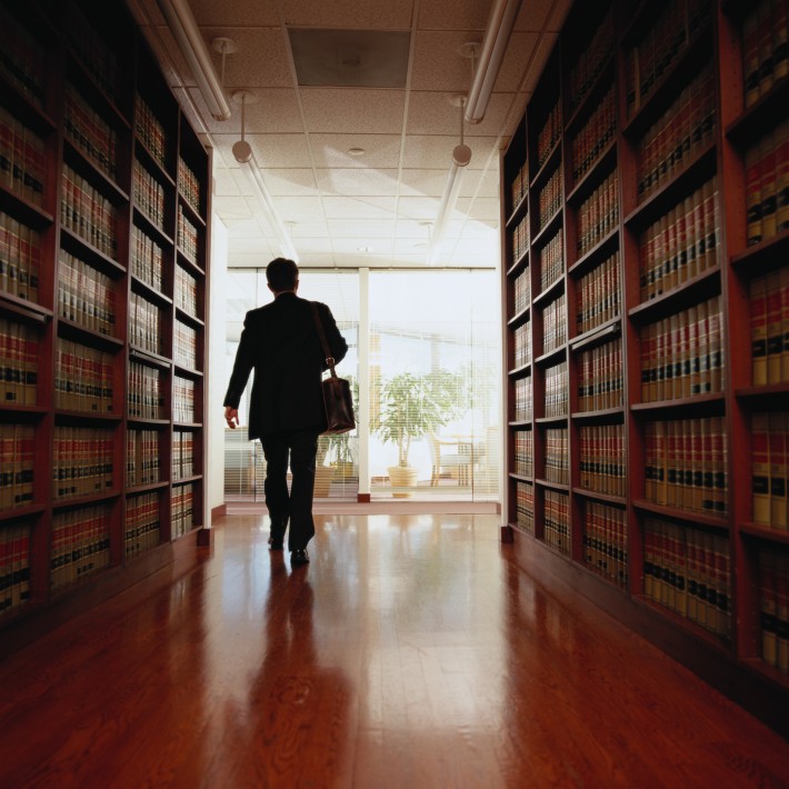 Lawyer Exiting a Law Library
